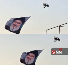 پرواز پاراگلایدر در آسمان بغداد با تصویر شهید سیدحسن نصرالله