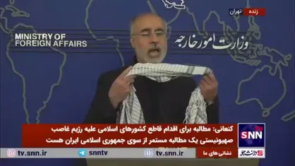 انداختن چفیه بر گردن توسط کنعانی هنگام تهدید کردن رژیم صهیونیستی