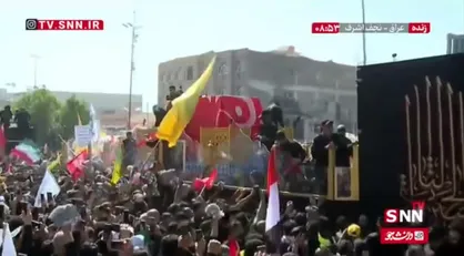 پرچم مقدس گنبد امام حسین (ع) روی پیکر مطهر رهبر شهید