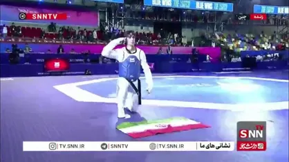 احترام نظامی زندی در برابر پرچم ایران پس از کسب مدال طلا