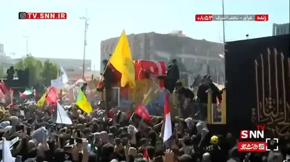 پرچم مقدس گنبد امام حسین (ع) روی پیکر مطهر رهبر شهید + فیلم